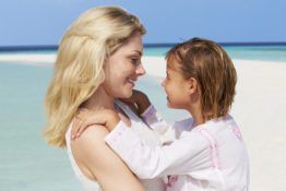 mother and daughter hugging on beautiful beach PQ5T8H3 scaled