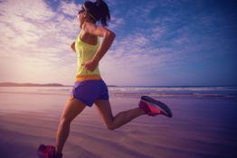 woman runner morning exercise on sunrise beach 2WB3G9Z scaled